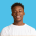 happy african american young man is smiling and wearing a white t-shirt isolated on blue background